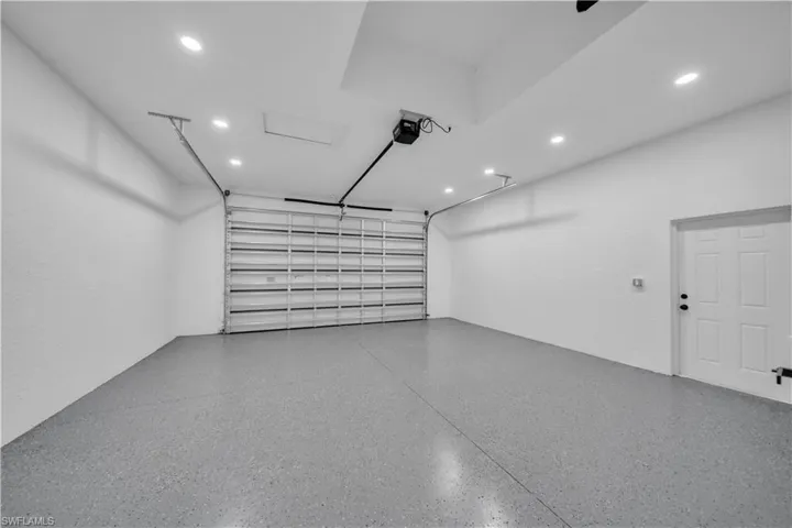 Garage with recessed lighting and a garage door opener