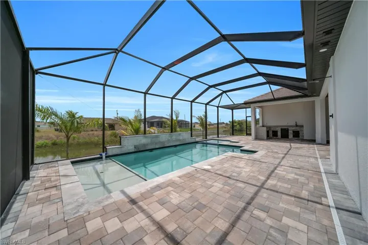 Swimming pool featuring a sunroom, a patio, and a lanai