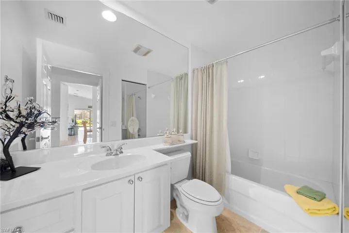 Bathroom with shower / tub combo and vanity