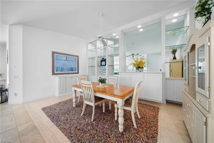 Dining room with built in features, a ceiling fan, recessed lighting, and light tile patterned flooring