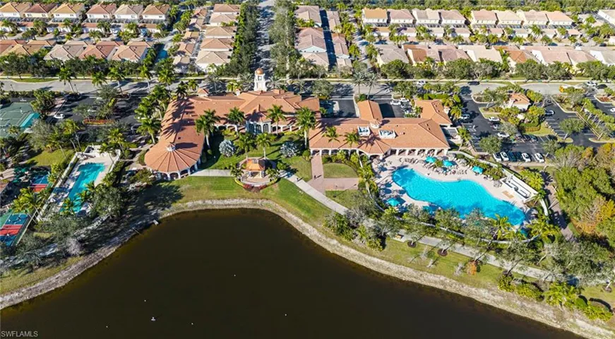 Drone / aerial view of a pool and a nearby body of water