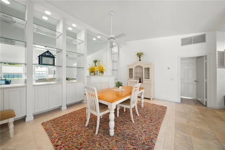 Dining space with ceiling fan, built in features, and recessed lighting