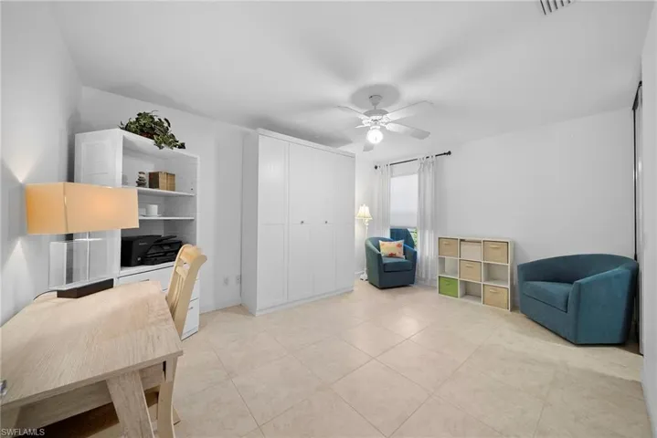 Office featuring ceiling fan and light tile patterned floors