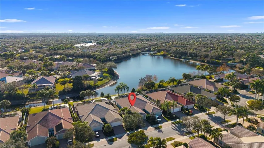 Aerial perspective of suburban area featuring a large body of water