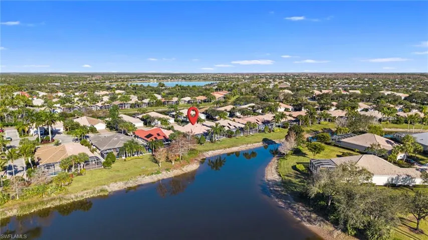 Aerial view of residential area featuring a nearby body of water