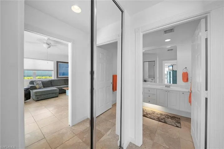 Full bathroom with vanity, recessed lighting, and a ceiling fan