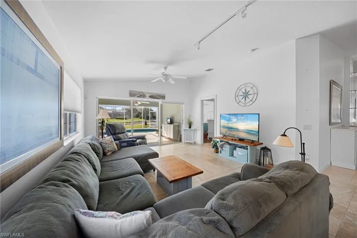 Living room with a ceiling fan and baseboards