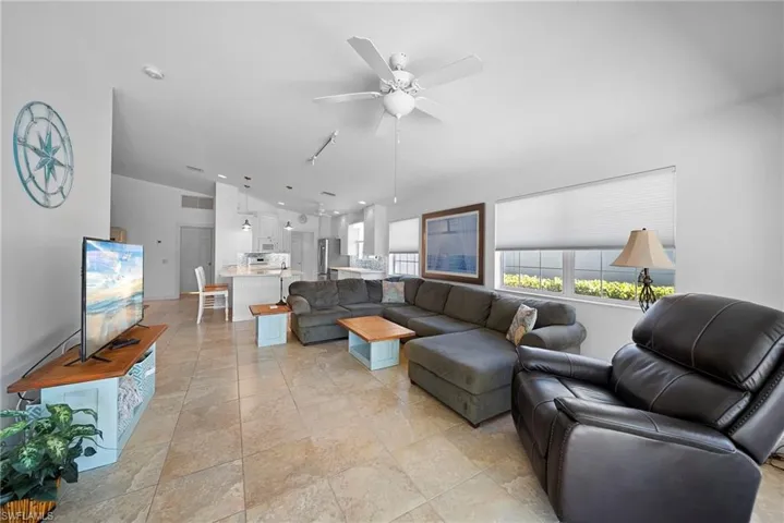 Living room with ceiling fan and vaulted ceiling