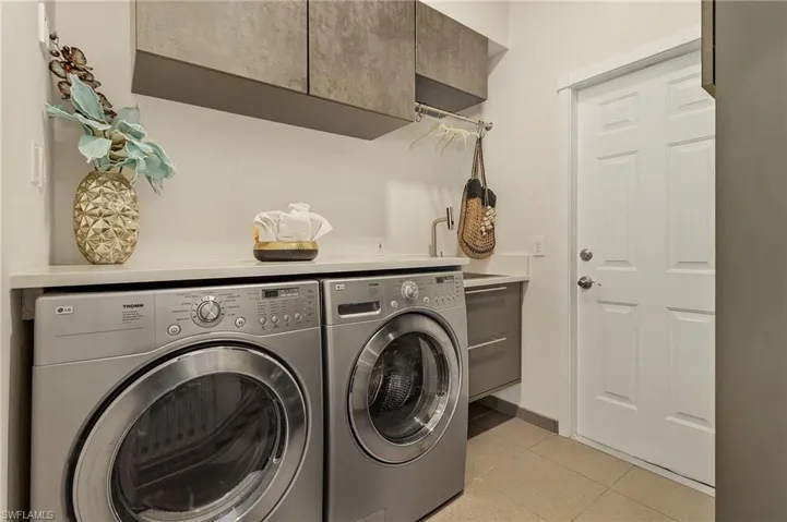 Clothes washing area with cabinets and independent washer and dryer
