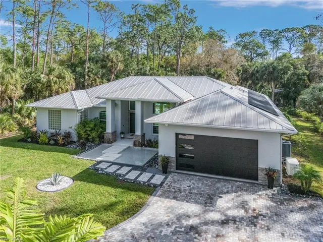 View of front of home featuring a garage and a front lawn