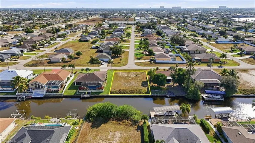 Aerial view of residential area featuring a nearby body of water
