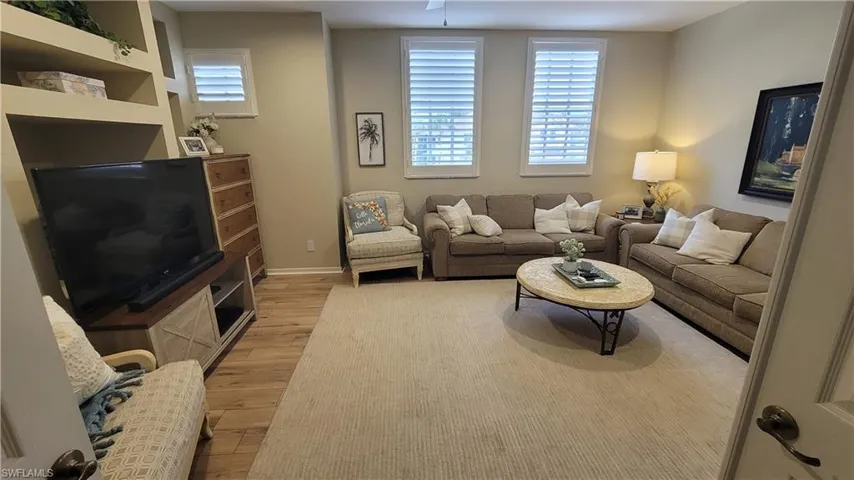 Living room with light wood finished floors and baseboards