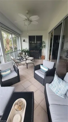 Sunroom featuring an outdoor lounge area and a ceiling fan