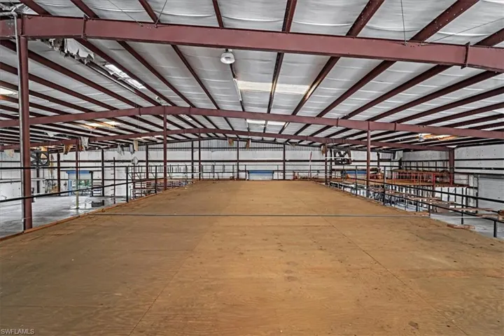 Open-span industrial interior featuring an elevated plywood platform