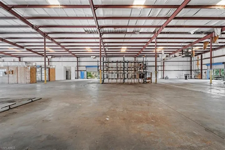 Spacious warehouse interior featuring a concrete floor and exposed steel beam construction