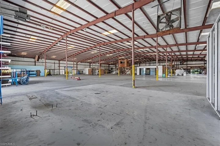 Expansive warehouse space featuring exposed metal beams and a high ceiling