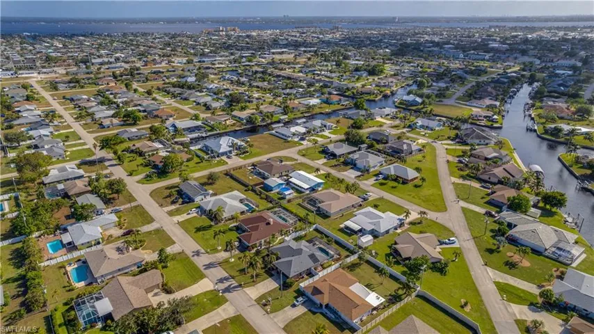 Birds eye view of property with a water view