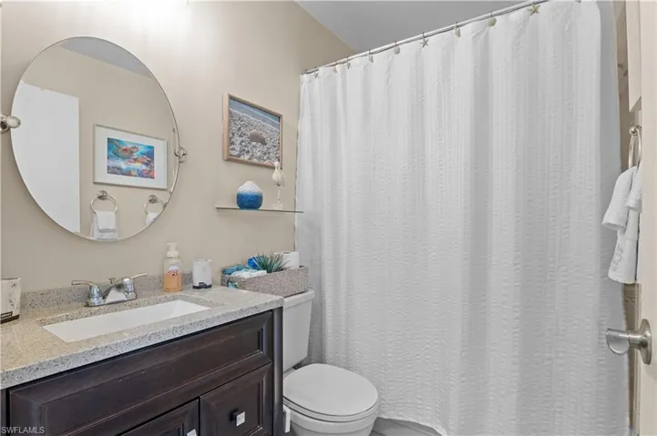 Bathroom featuring vanity and a shower with shower curtain