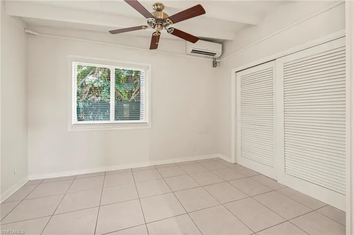 Unfurnished bedroom with light tile patterned flooring