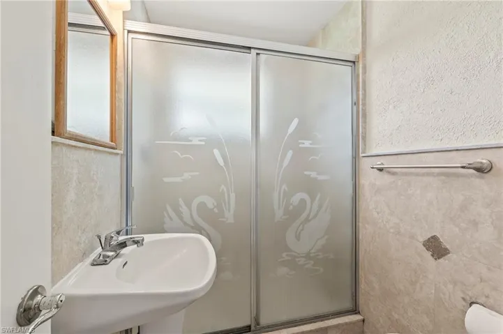 Full bathroom with a shower stall and a sink