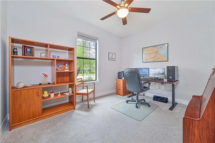 Carpeted office with ceiling fan