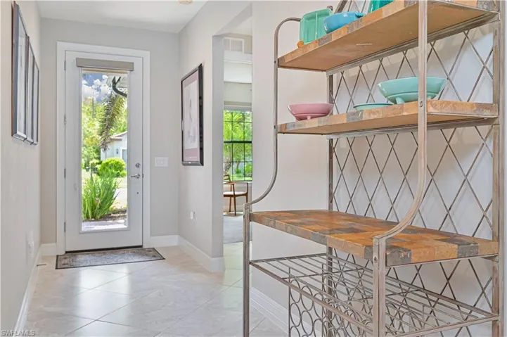 Entrance foyer featuring light tile patterned floors and a healthy amount of sunlight