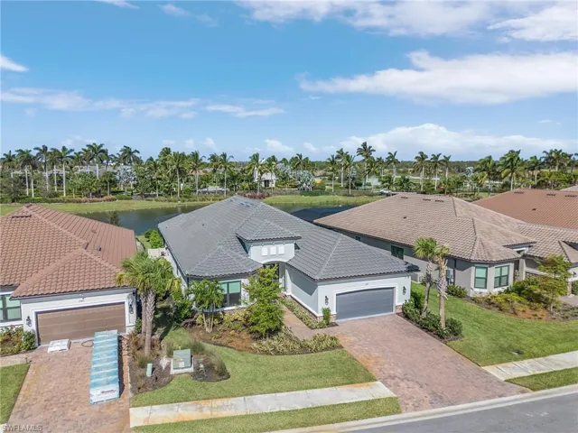 Birds eye view of property with a water view