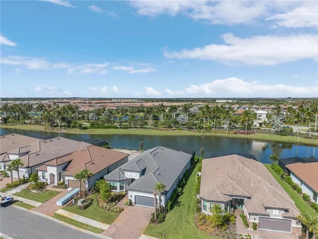 Birds eye view of property with a water view