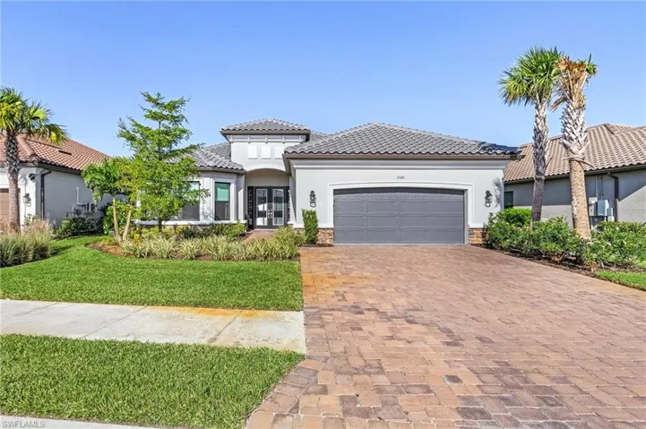 Mediterranean / spanish home featuring a front yard and a garage