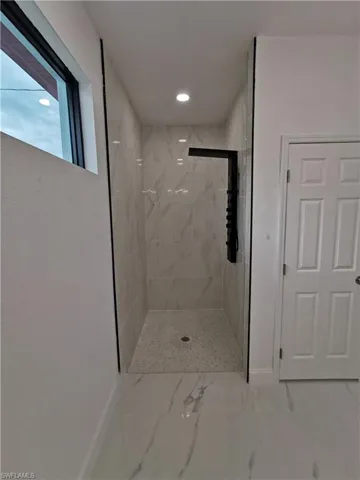 Full bathroom with a marble finish shower, marble finish floors, and recessed lighting