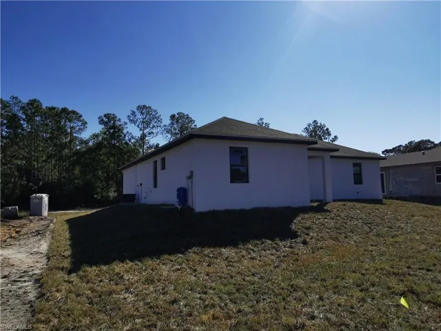 Prairie-style house with stucco siding, driveway, and an attached garage