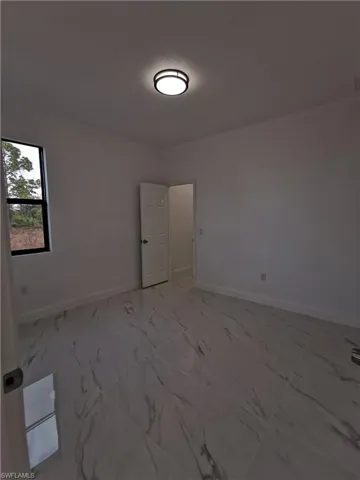 Unfurnished room featuring light marble finish flooring