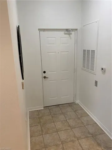 Doorway with tile patterned floors