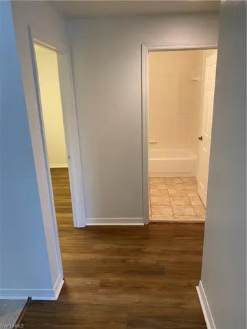 Hallway with dark wood-type flooring