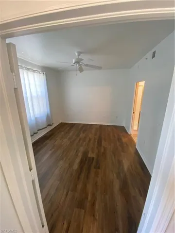 Spare room featuring ceiling fan and wood-type flooring