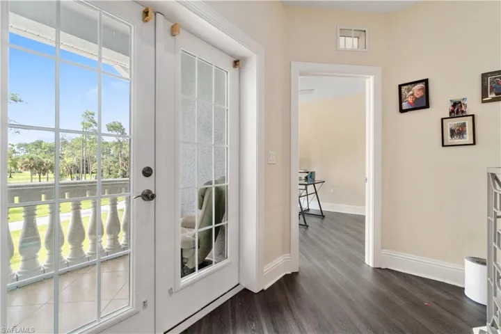 Entryway featuring dark wood-style flooring and baseboards