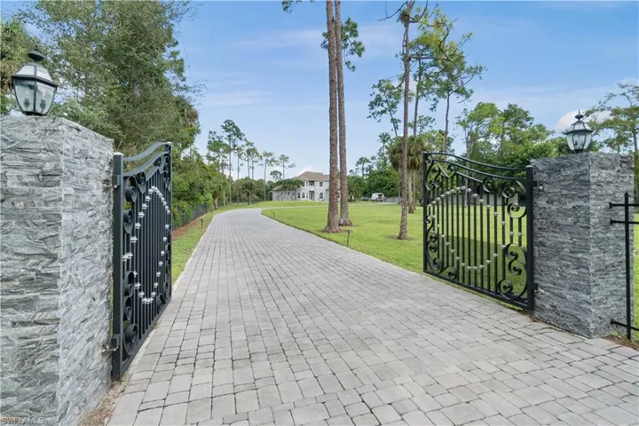 View of gate featuring a lawn