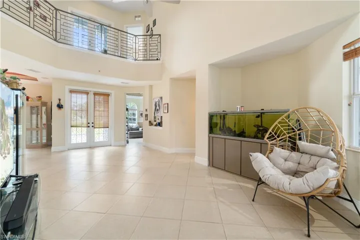 Entryway with light tile patterned floors, french doors, plenty of natural light, and baseboards