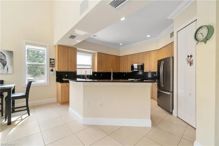 Kitchen featuring dark countertops, visible vents, and stainless steel appliances