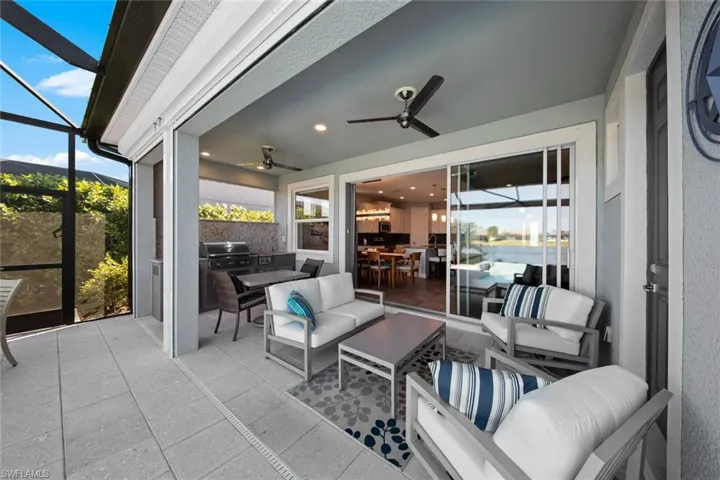 Large covered lanai area with POOL BATH, OUTDOOR KITCHEN, and ELECTRIC HURRICANE SCREENS.