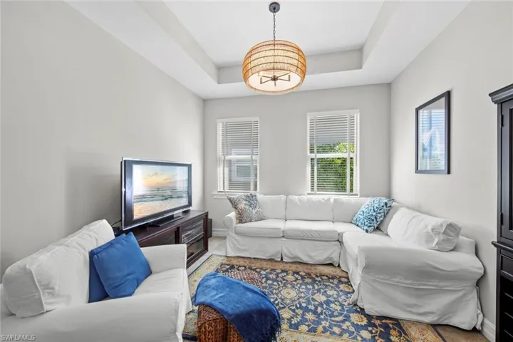 The tile floor extends into the den with TRAY CEILING, window blinds (April 2017), and new chandelier (July 2022).