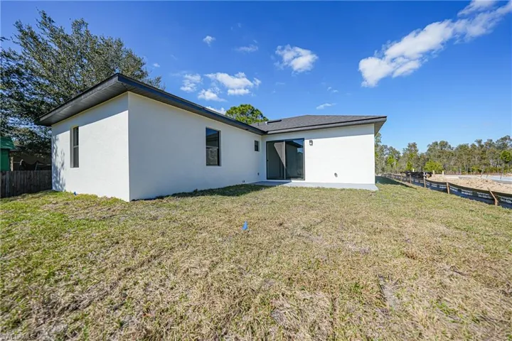 Back of house featuring stucco siding and a patio