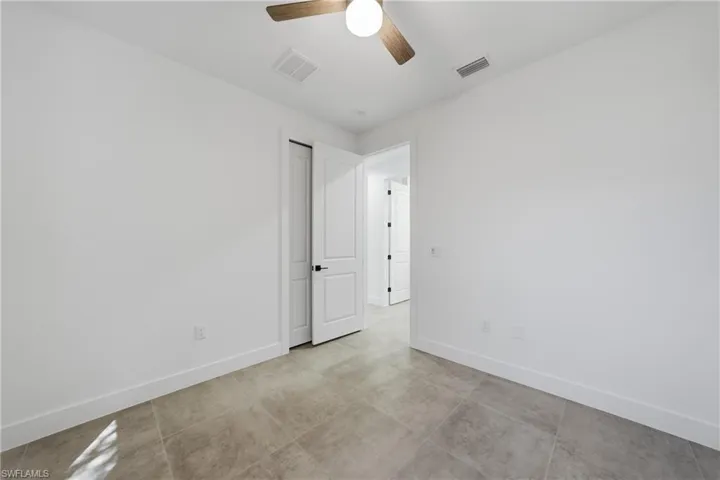 Spare room with baseboards and ceiling fan