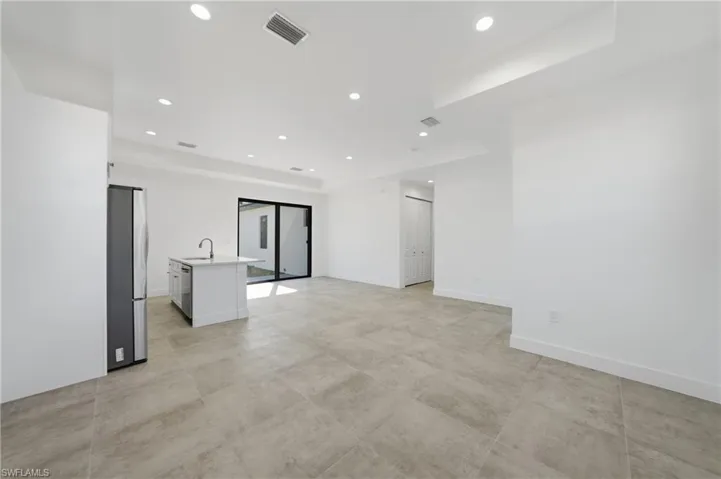 Empty room featuring recessed lighting and a raised ceiling