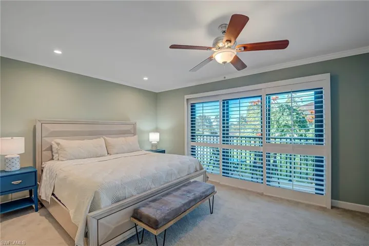 Bedroom featuring light colored carpet, ceiling fan, crown molding, and recessed lighting