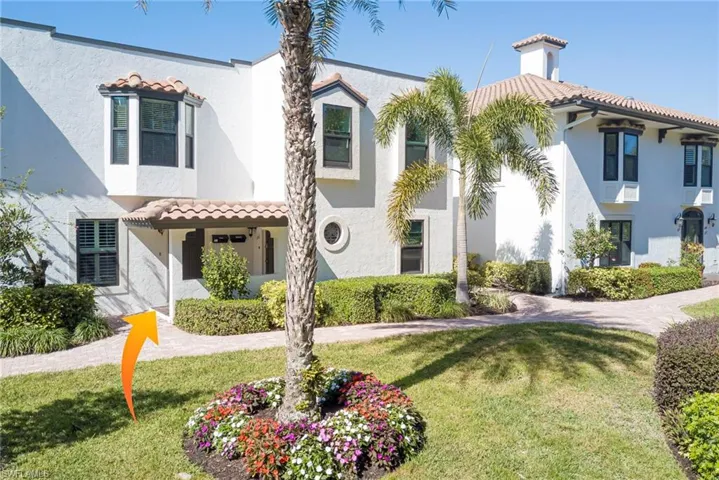 Mediterranean style home with a front lawn and stucco siding