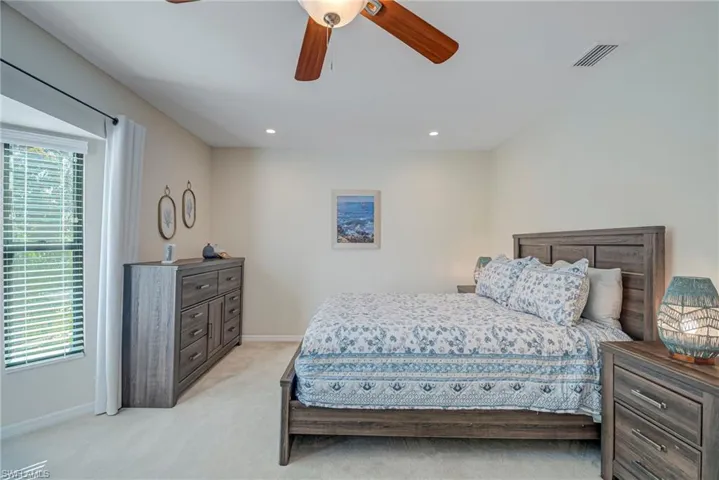 Bedroom with light carpet, a ceiling fan, and recessed lighting. This room could be used as a home office or have two twin beds.
