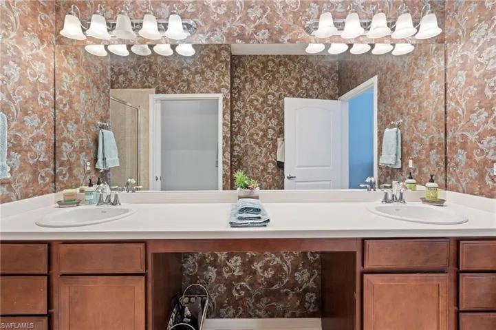 Bathroom featuring vanity and an enclosed shower
