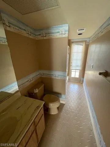 Bathroom with vanity, a shower stall, and light tile patterned floors