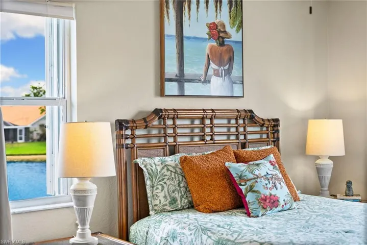 Bedroom with multiple windows and a water view
